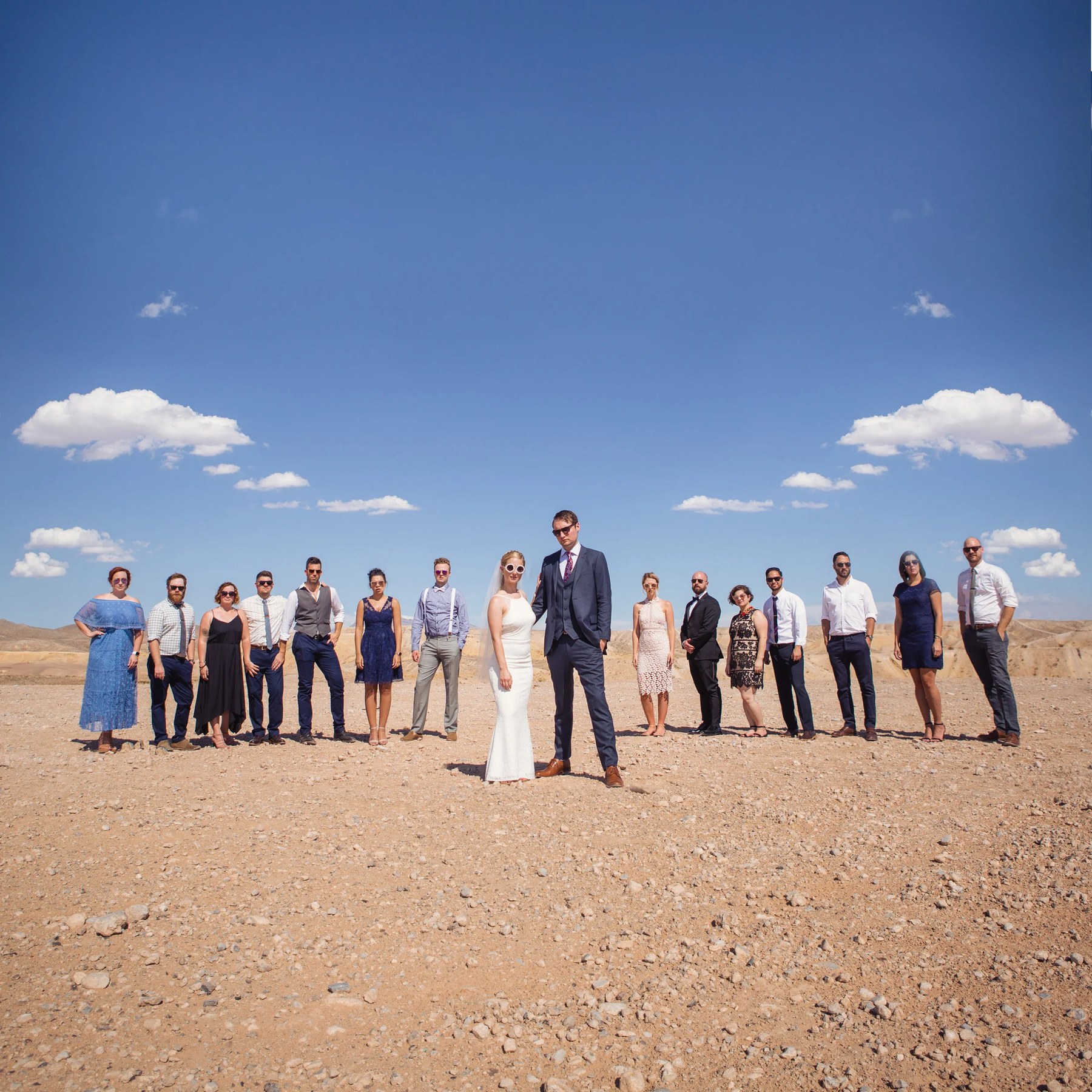 Wedding party standing in the desert